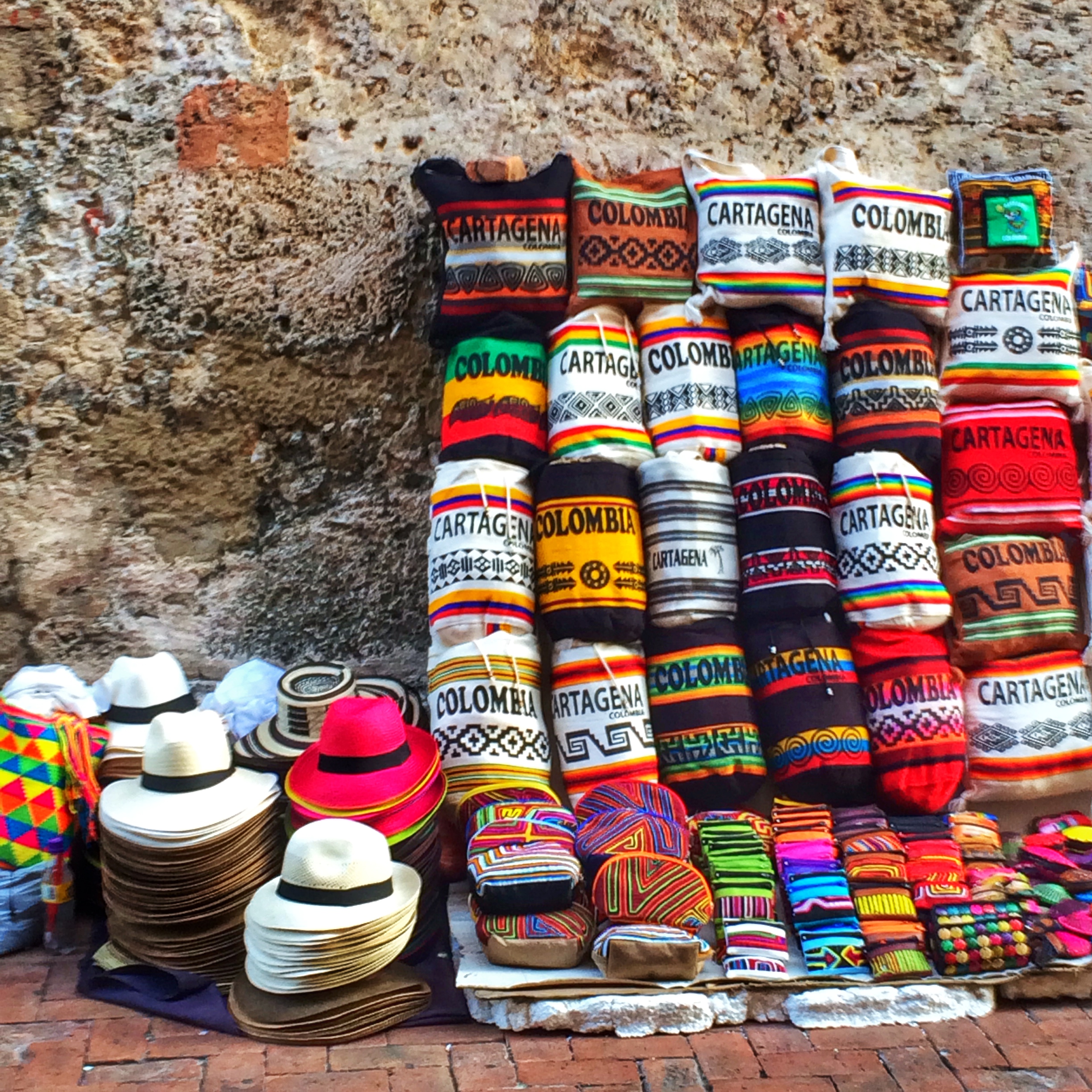 Street Vendor Selling Hats, Bags, and Other Souvenirs