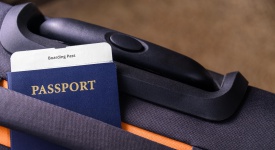 Passport and a boarding pass on a suitcase