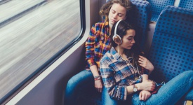 lesbian couple sleeping on a train