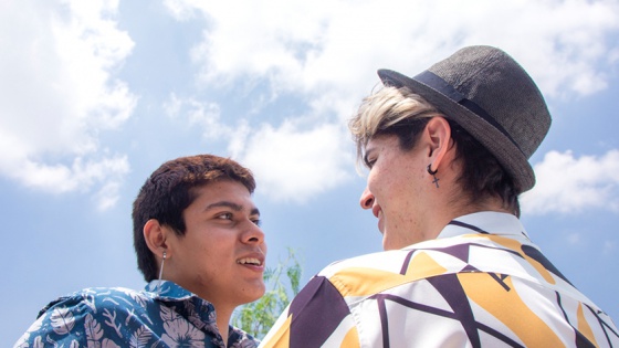 two men smiling at each other