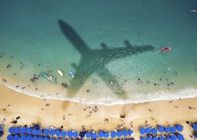 Airplane's shadow over a crowded beach